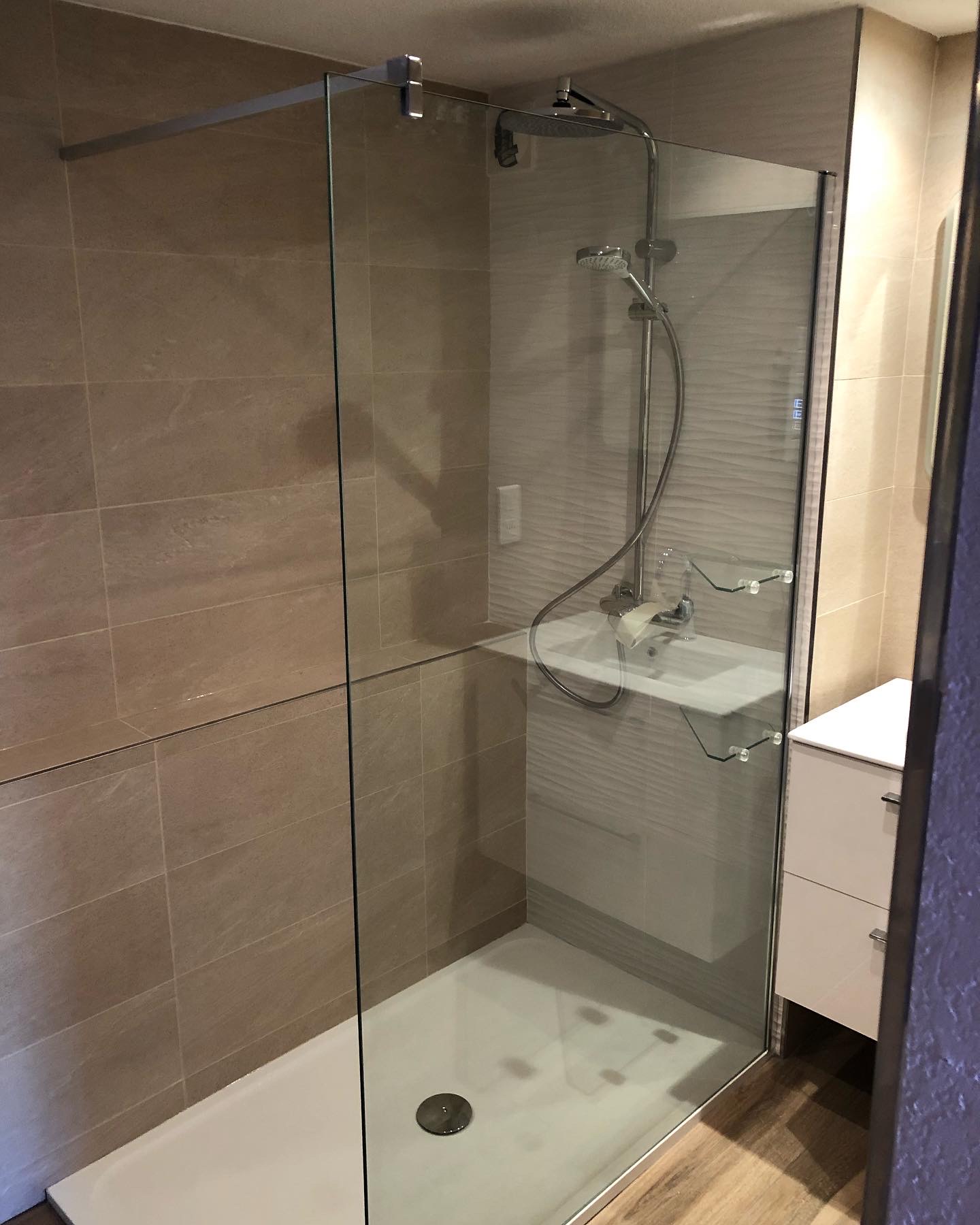 Salle de bain beige avec douche